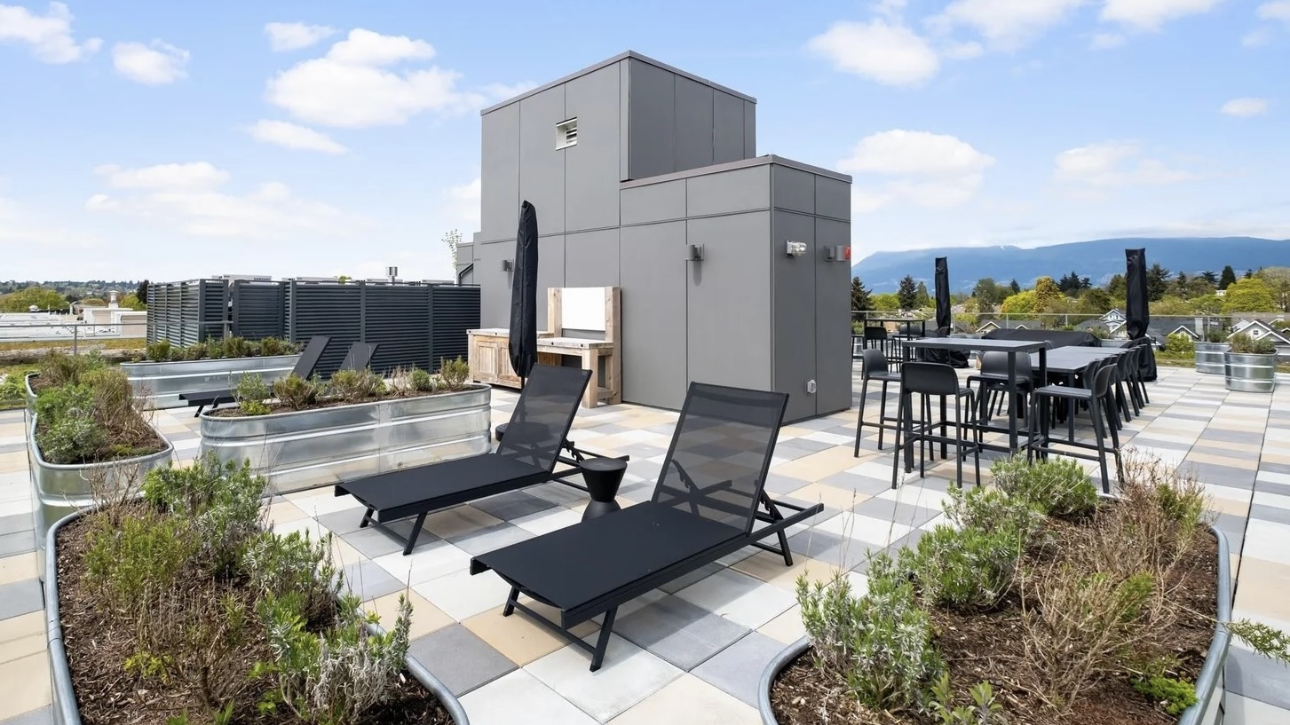 Vancouver rooftop patio — lounge chairs with mountain views